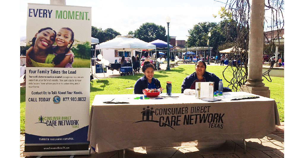 Jennifer and Norma sitting at the Consumer Direct Care Network Texas booth on a sunny day.
